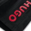 Badshorts för barn med vertikalt logotryck