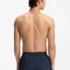Badshorts med upprepade logotyper