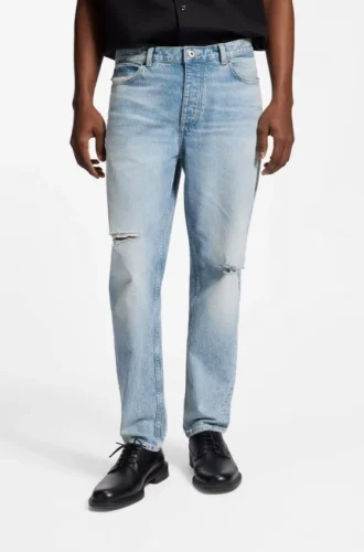Blå jeans med avsmalnande passform i slitna denim