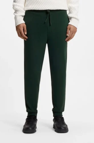 Joggingbyxor med muddar i bomullsfrotté med logotryck