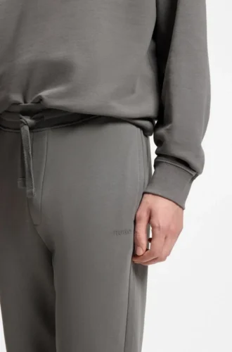 Joggingbyxor med muddar i bomullsfrotté med logotryck