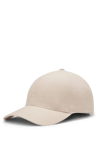 Kepsar i linne med broderad logotyp